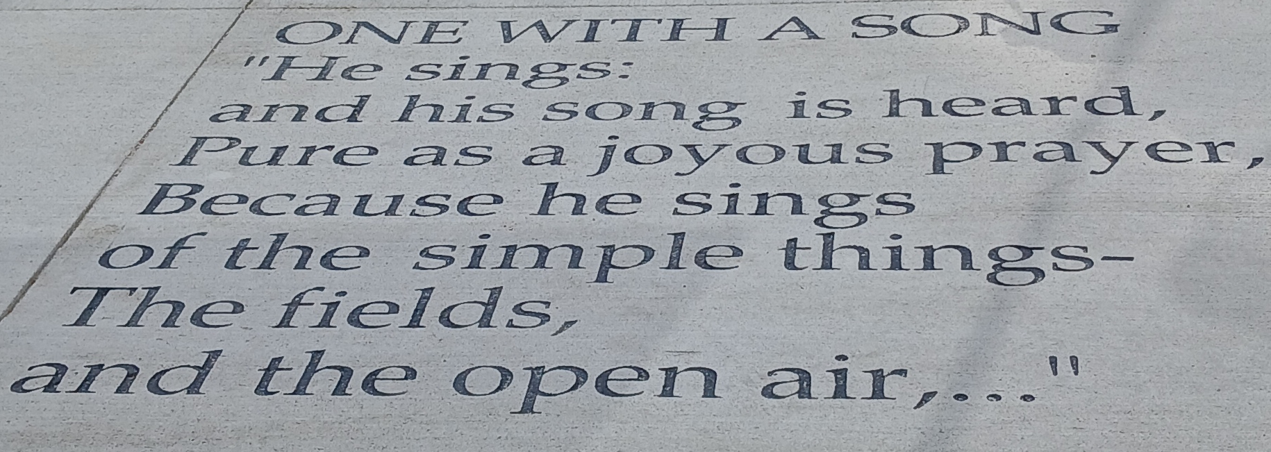 "One With A Song" poem engraved in sidewalk
