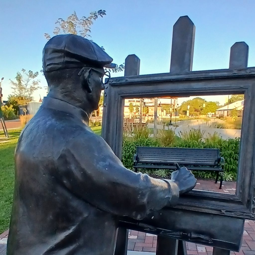 Will Vawter statue with a park bench in frame