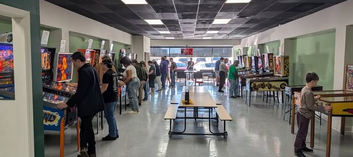 Visitors to the Greensboro Pinball Machine Museum try out the pinball machines on opening day.